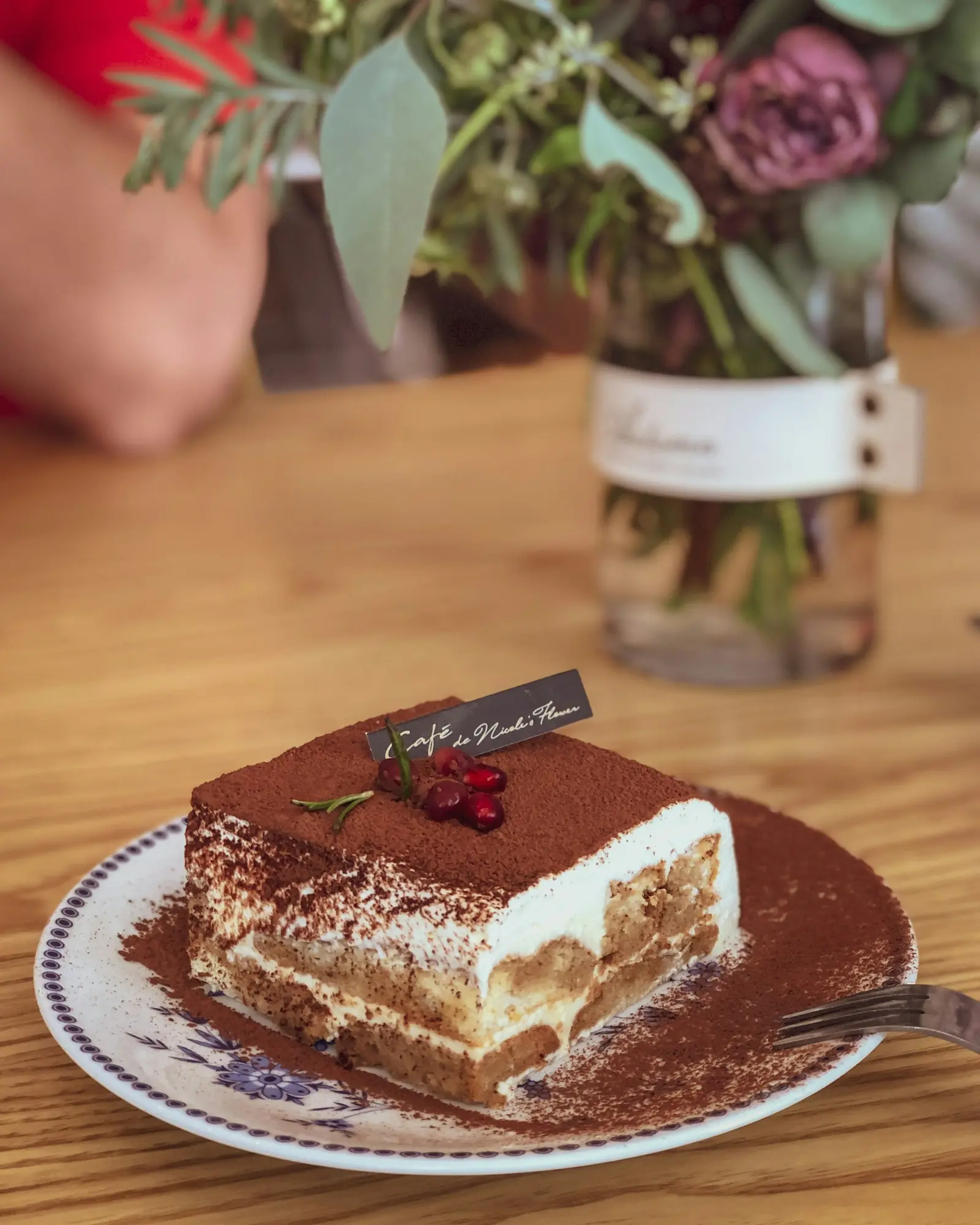 Tiramisu on a plate with cocoa dusting